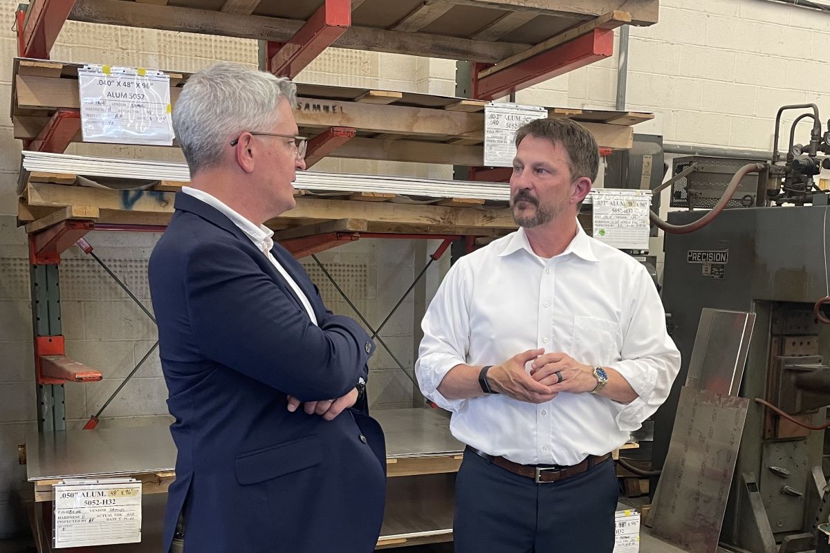 Congressman Brandon Williams talks with Eagle Metalcraft owner and fellow veteran Michael Bower.