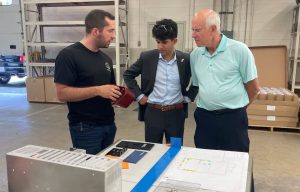 Eagle Metalcraft team member Jon shows Congressman Williams representatives Ari (center) and Mark final products from CNY Graphics, our onsite silk screening and printing facility.